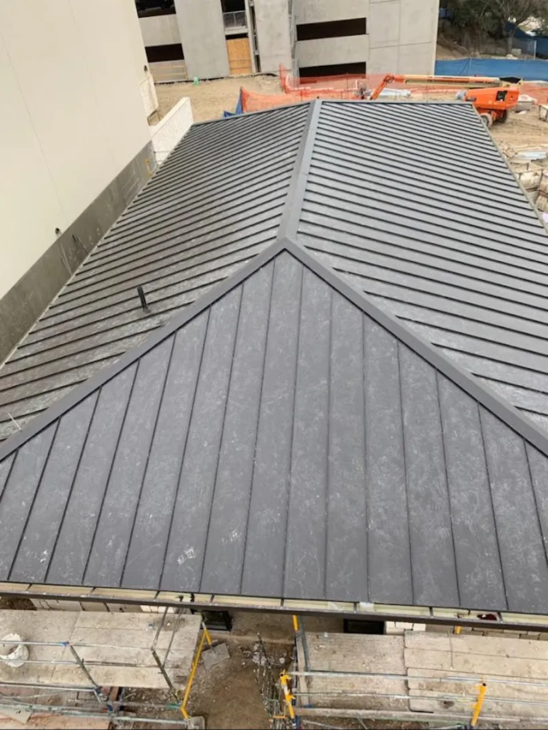 Commercial metal roof construction with crane equipment in Palatine