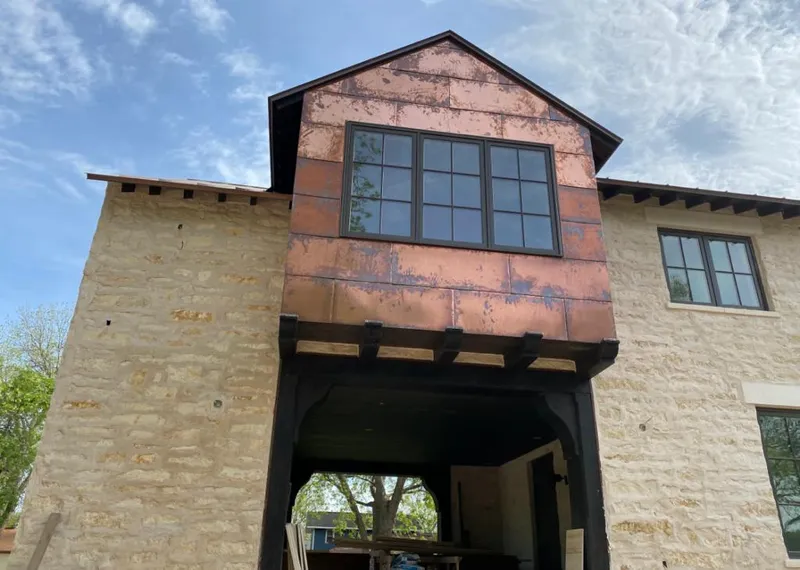 Copper metal panel facade on a stone building for Skylight Installation in Palatine