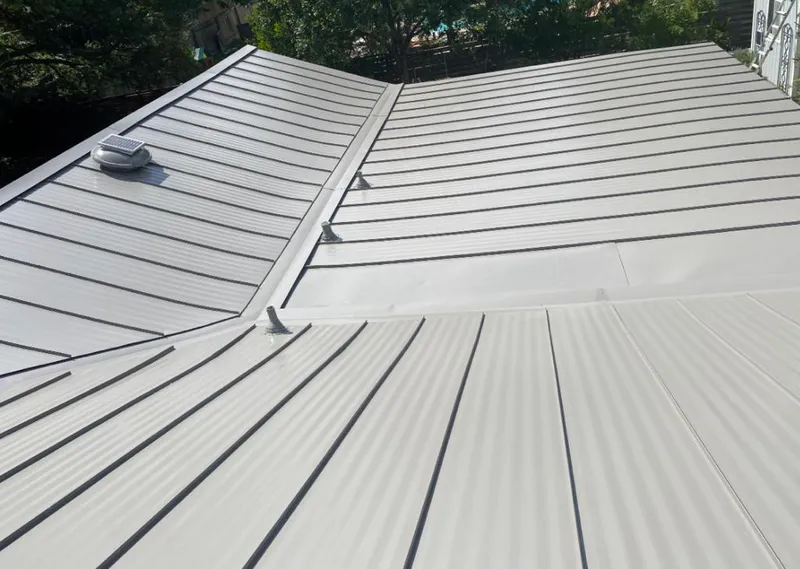 Solar attic fan installed on a metal roof for Roof Ventilation in Palatine